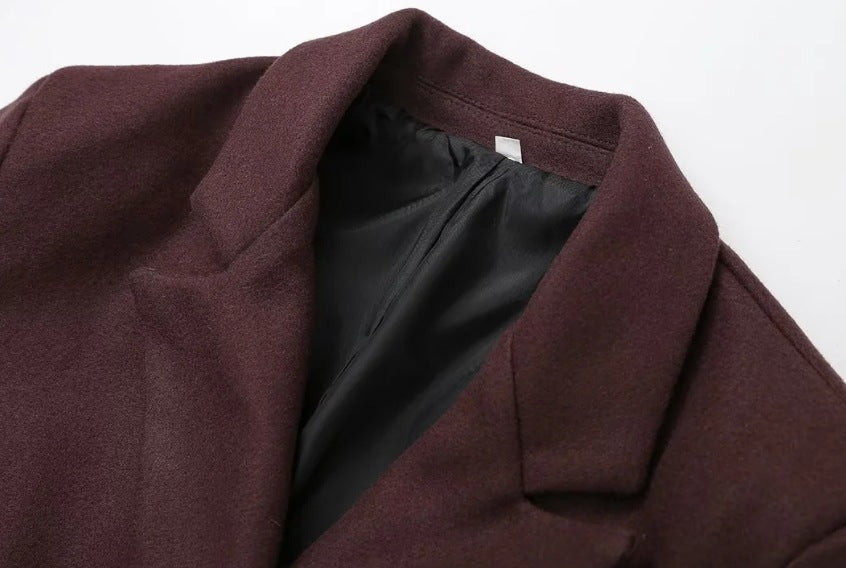 Double breasted coat with padded shoulders and lapel